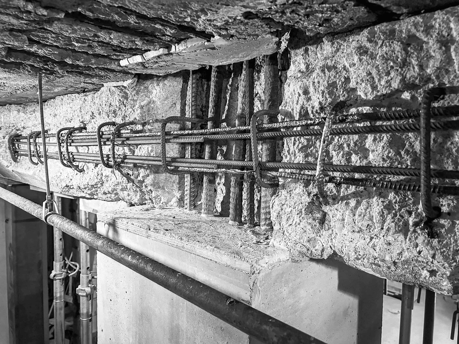 Badly deteriorated concrete with the reinforcing cage exposed