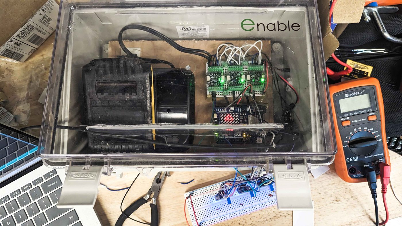 Open enclosure with Enable-built data acquisition boards and a multimeter