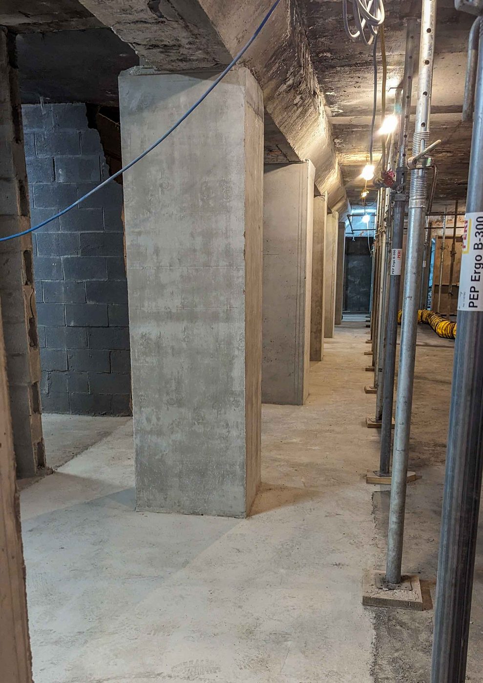 New smooth concrete columns in a parking level corridor